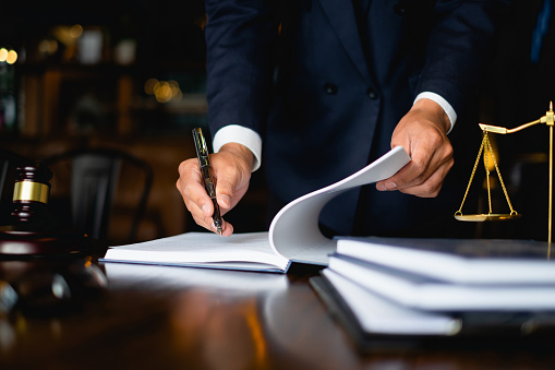 Close Up Lawyer Businessman Working Or Reading Lawbook In Office Workplace For Consultant Lawyer Concept.