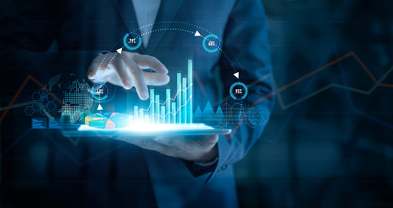 Businessman Using Tablet Analyzing Sales Data And Economic Growth Graph Chart On Virtual Interface. Business Strategy. Abstract Icon. Digital Marketing.